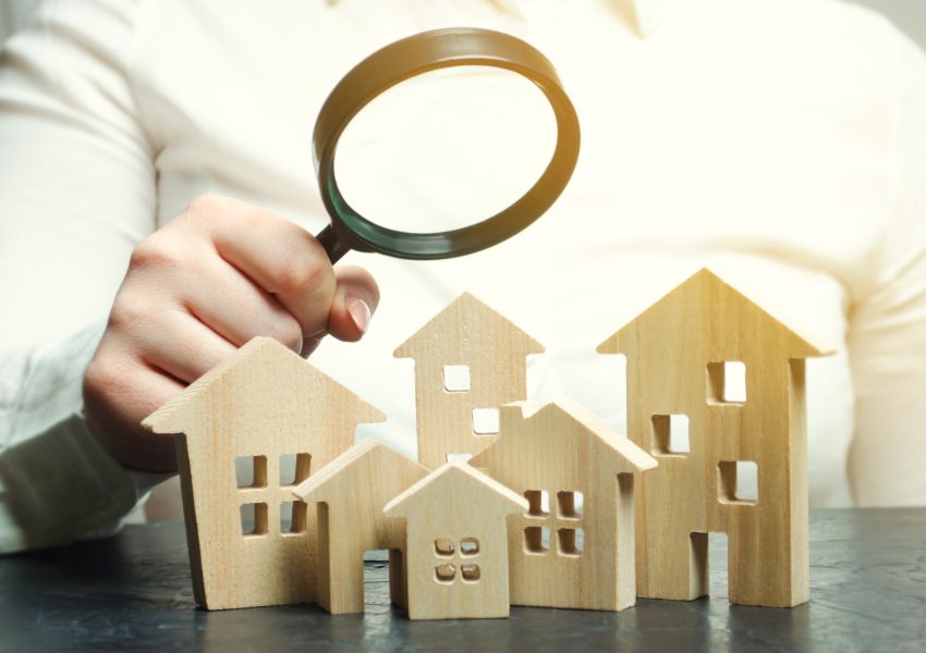 your using a magnifying glass to look at different sized house figurines